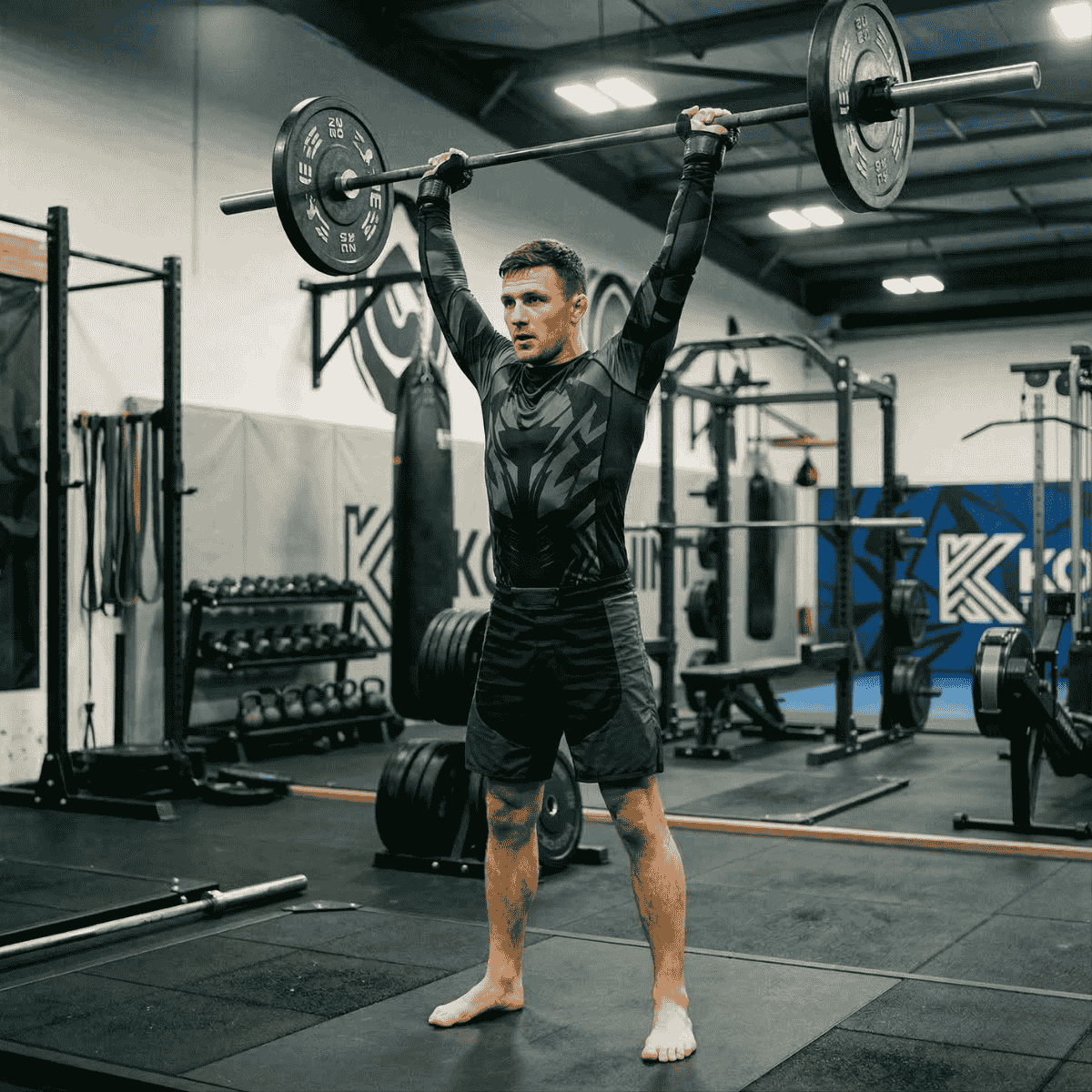 Man lifting a barbell in a gym setting